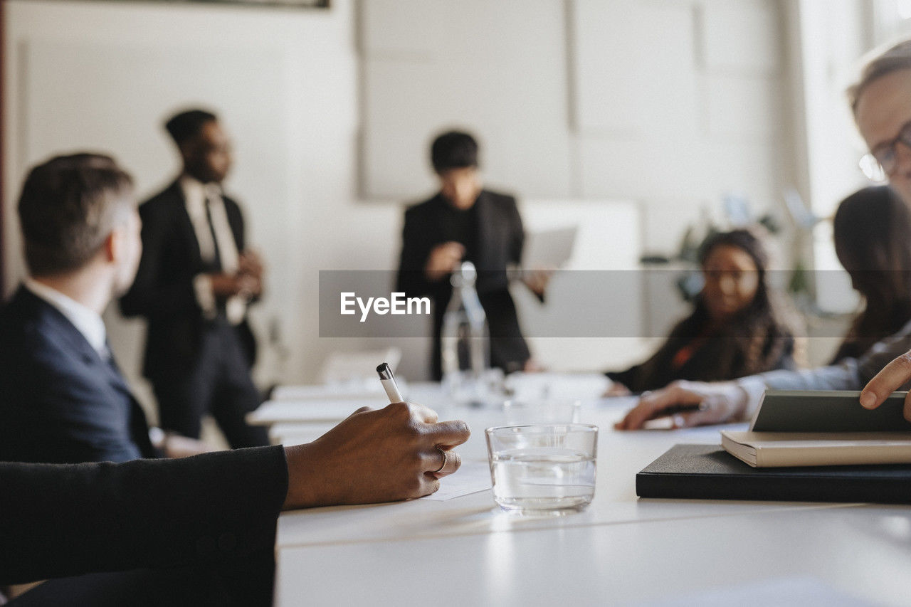 Hand of businesswoman taking down notes during business meeting at office