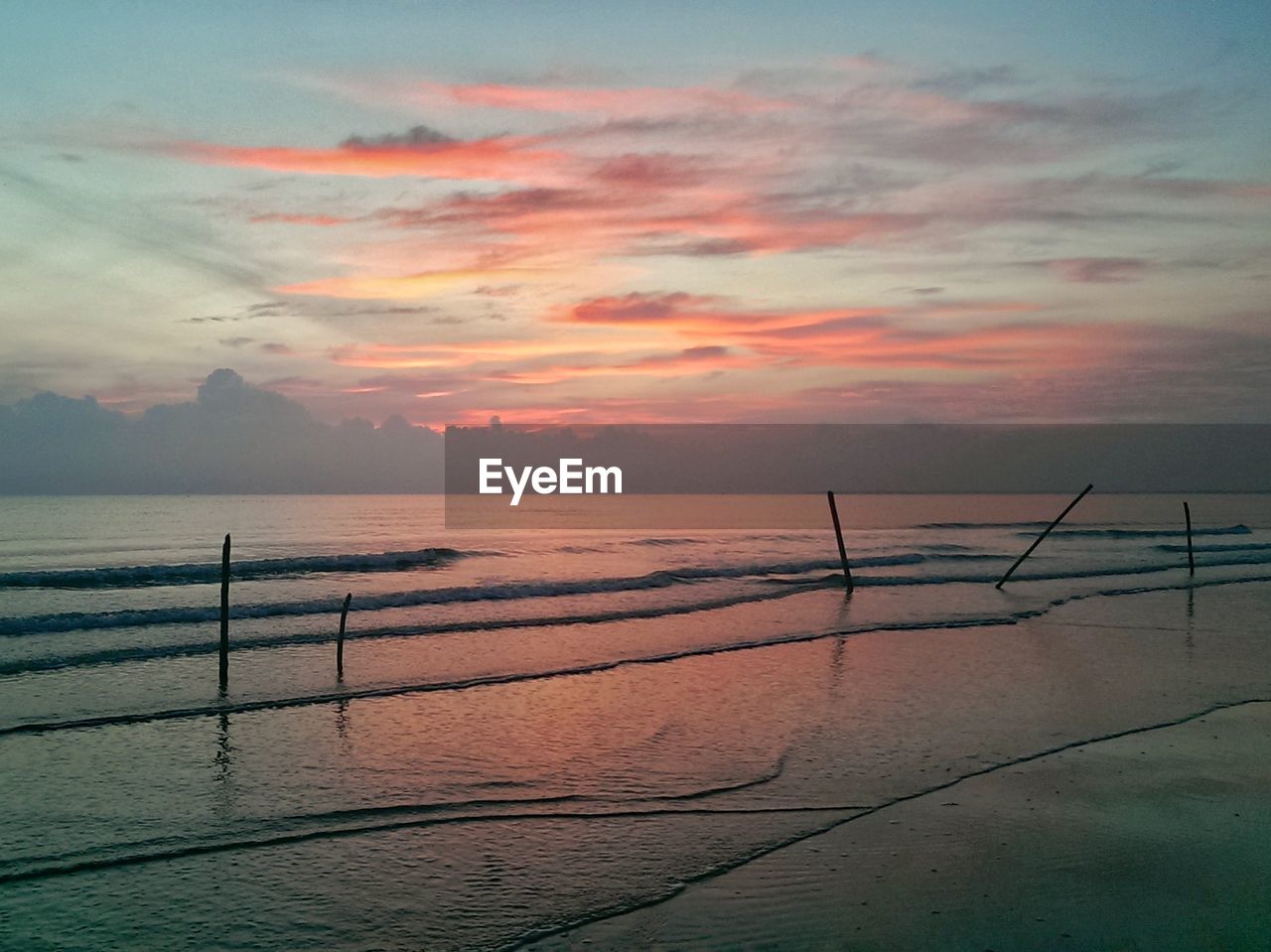 Scenic view of beach against sky during sunset