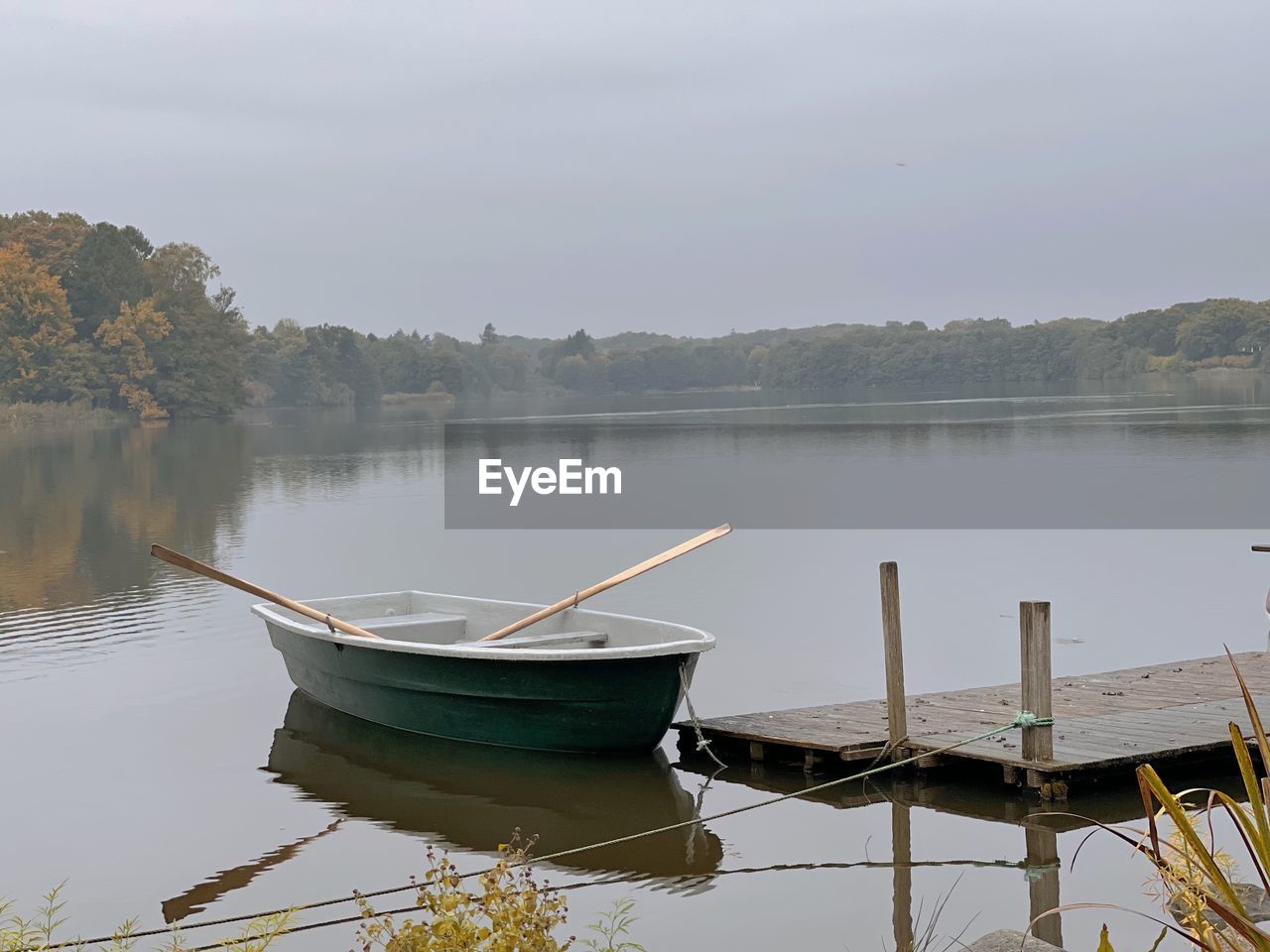 water, lake, reflection, nautical vessel, nature, tranquility, transportation, tranquil scene, sky, boat, vehicle, scenics - nature, beauty in nature, no people, reservoir, morning, environment, mode of transportation, boating, wood, shore, rowboat, moored, plant, fog, landscape, non-urban scene, travel, tree, day, fishing, outdoors, activity, pier, travel destinations, beach, bay, lakeshore, land