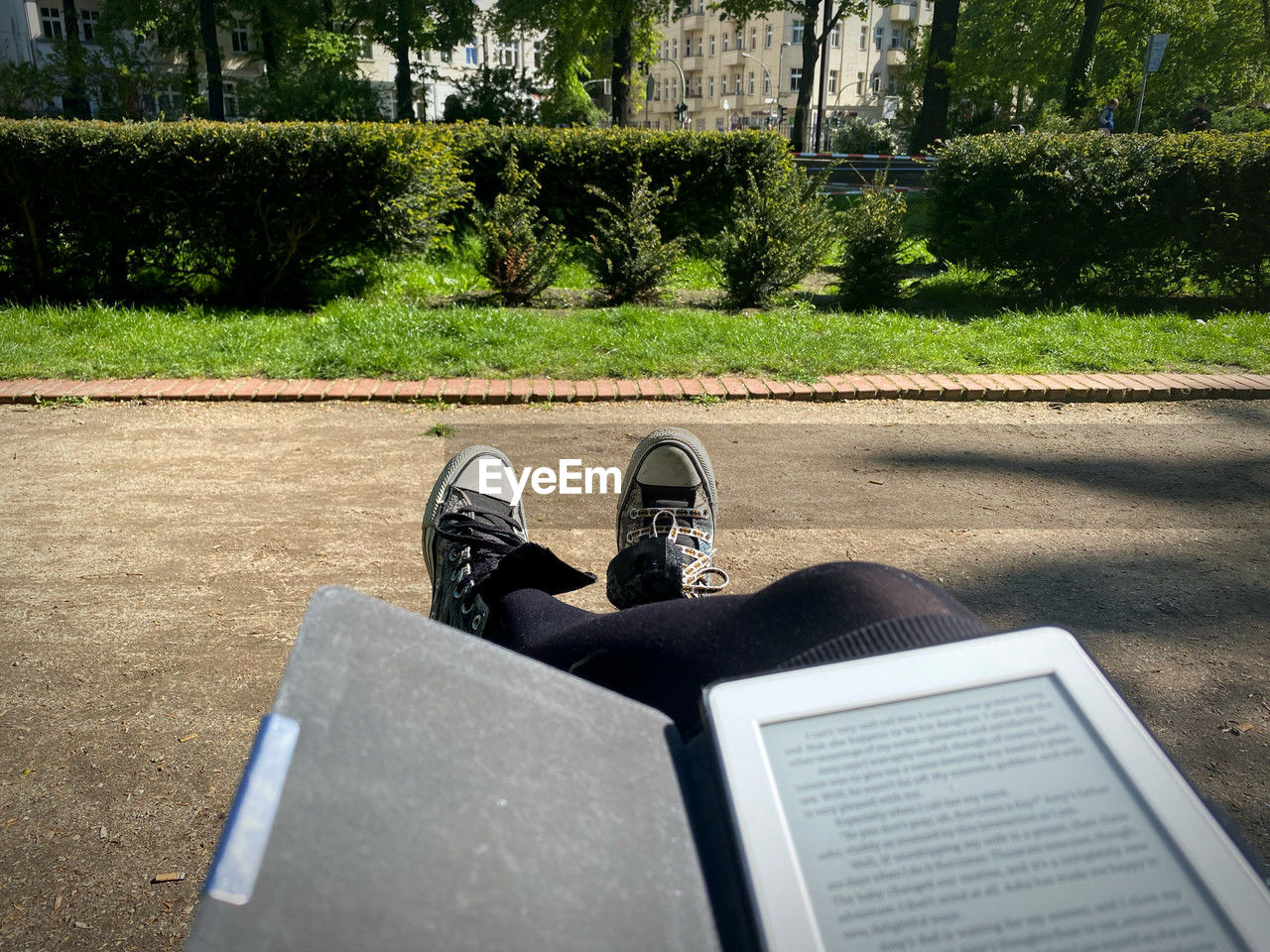 plant, human leg, low section, one person, day, nature, shoe, men, lifestyles, leisure activity, personal perspective, sunlight, footwear, tree, green, outdoors, high angle view, relaxation, sitting, grass, limb, park, book, park - man made space, publication, adult, shadow, memorial