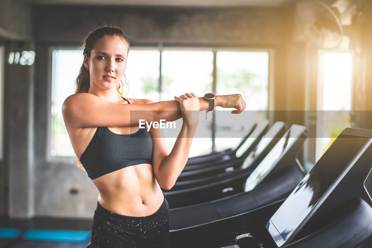 Confident woman exercising in gym