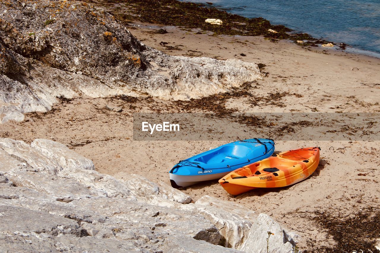 HIGH ANGLE VIEW OF TOY ON ROCK