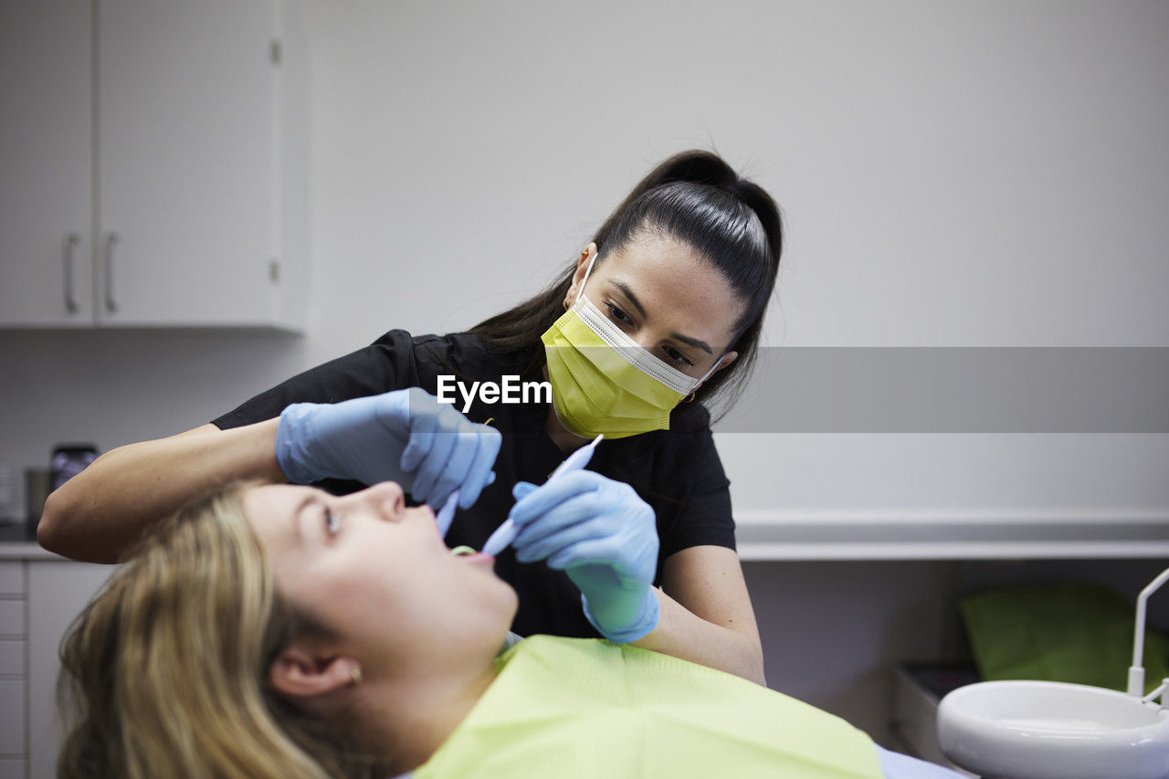 Female dentist with patient in office