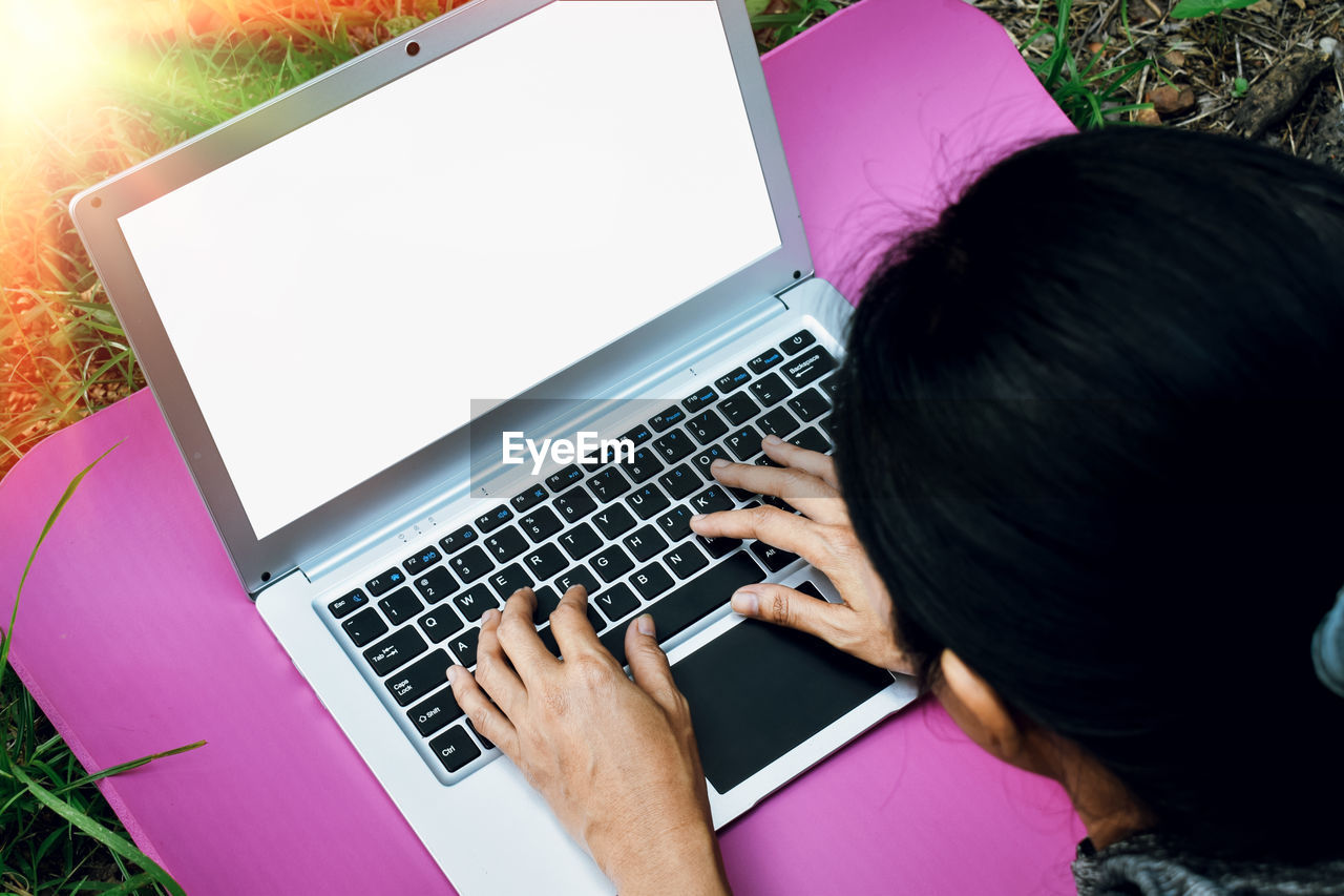 High angle view of woman using laptop on table