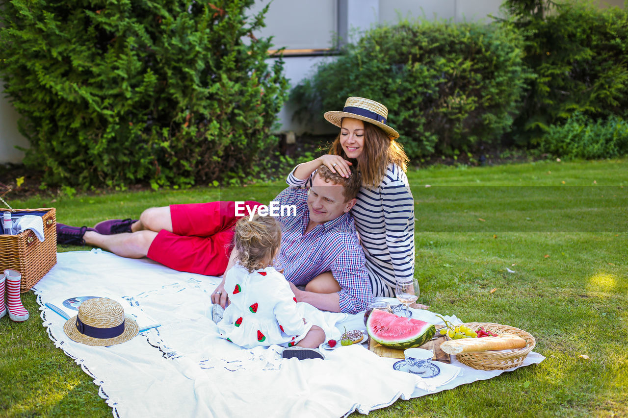 Parents with daughter enjoying picnic in park