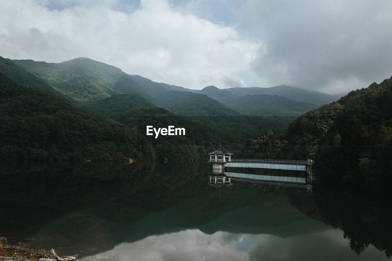 Scenic view of lake and mountains against sky