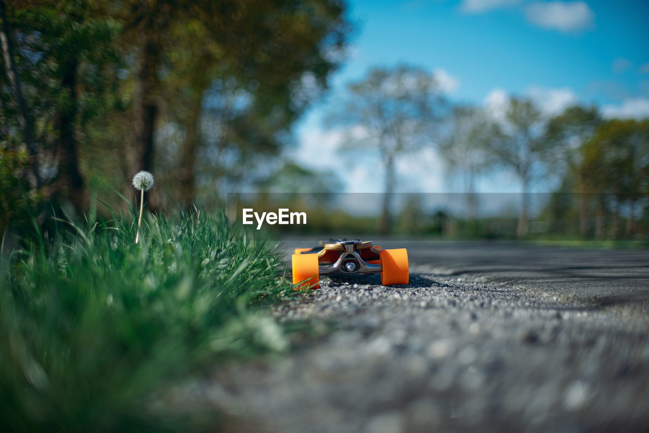 Close up of skateboard on road