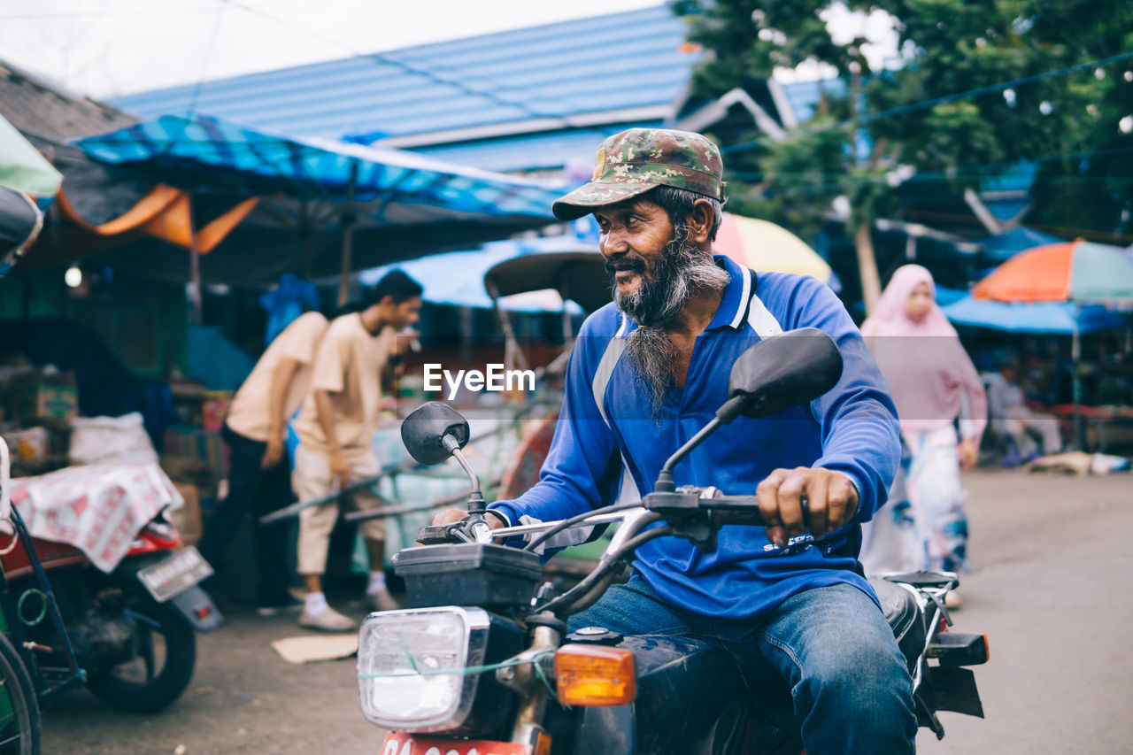 View of man on motorcycle at street market