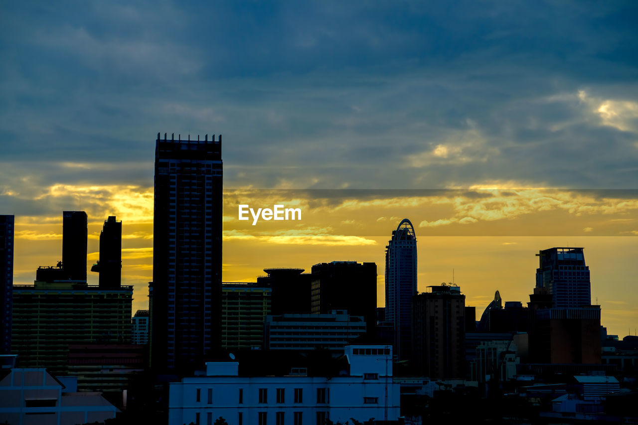 Modern buildings in city against sky during morning