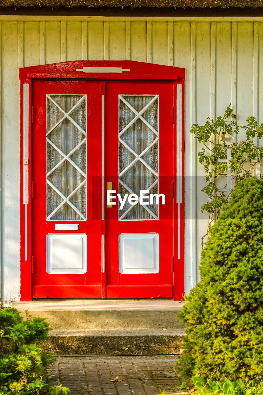 RED CLOSED DOOR OF HOUSE