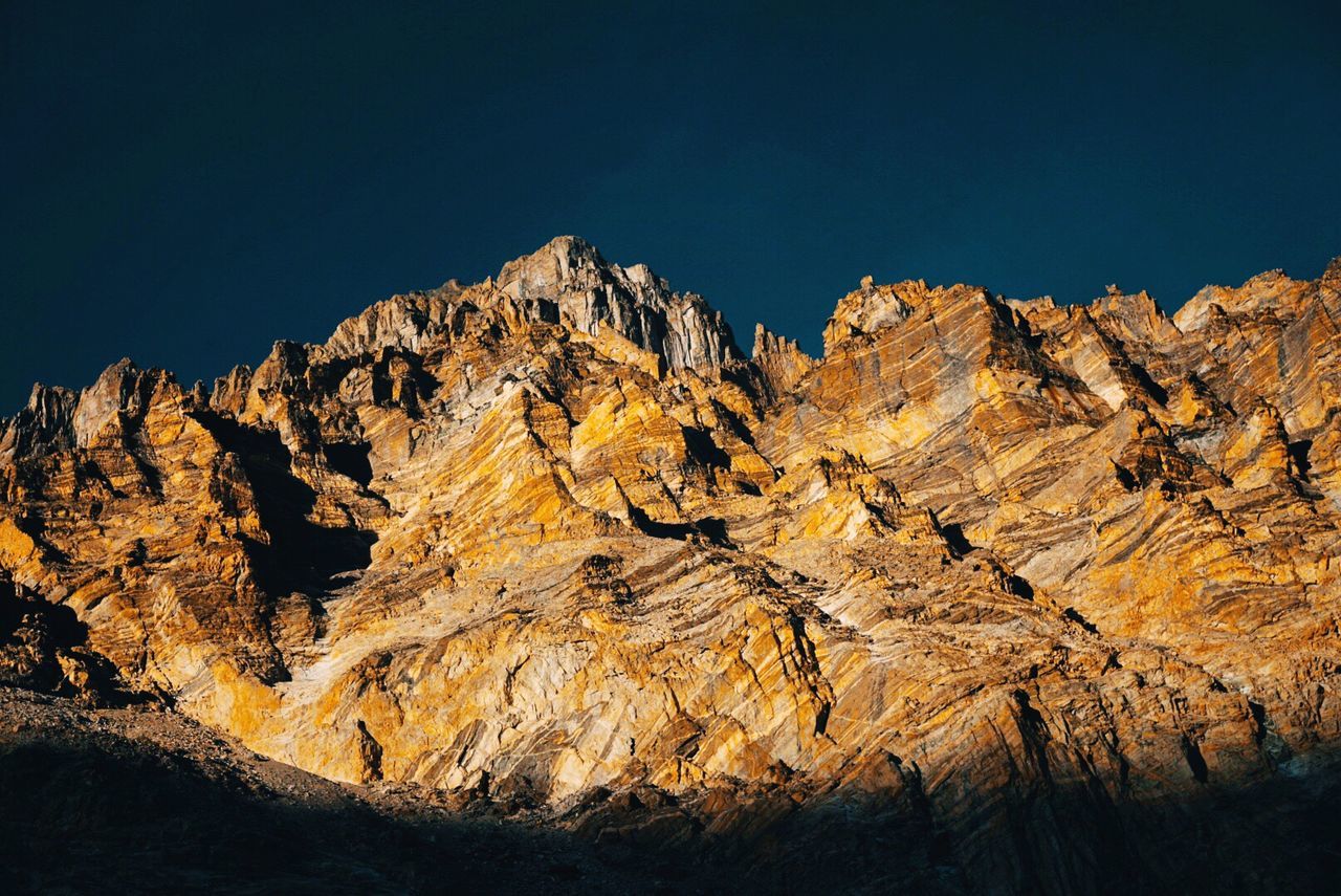 Low angle view of rock formation against sky