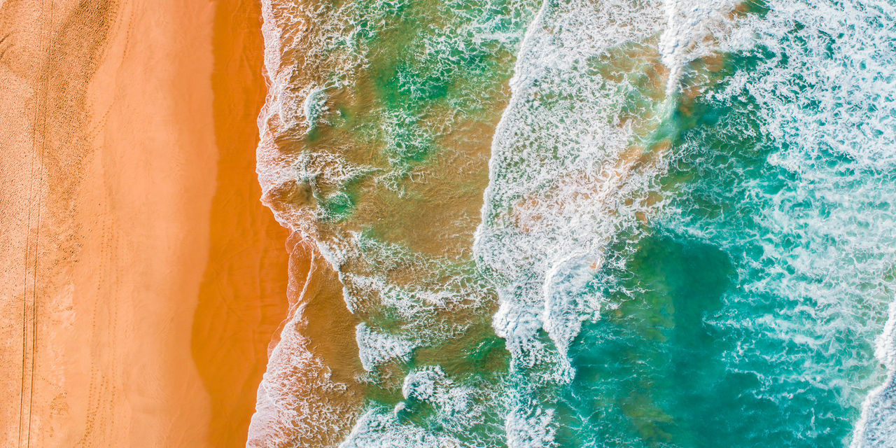FULL FRAME SHOT OF MULTI COLORED ROCK IN SEA