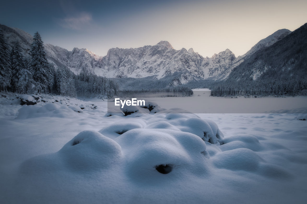 Scenic view of snow covered mountains against sky