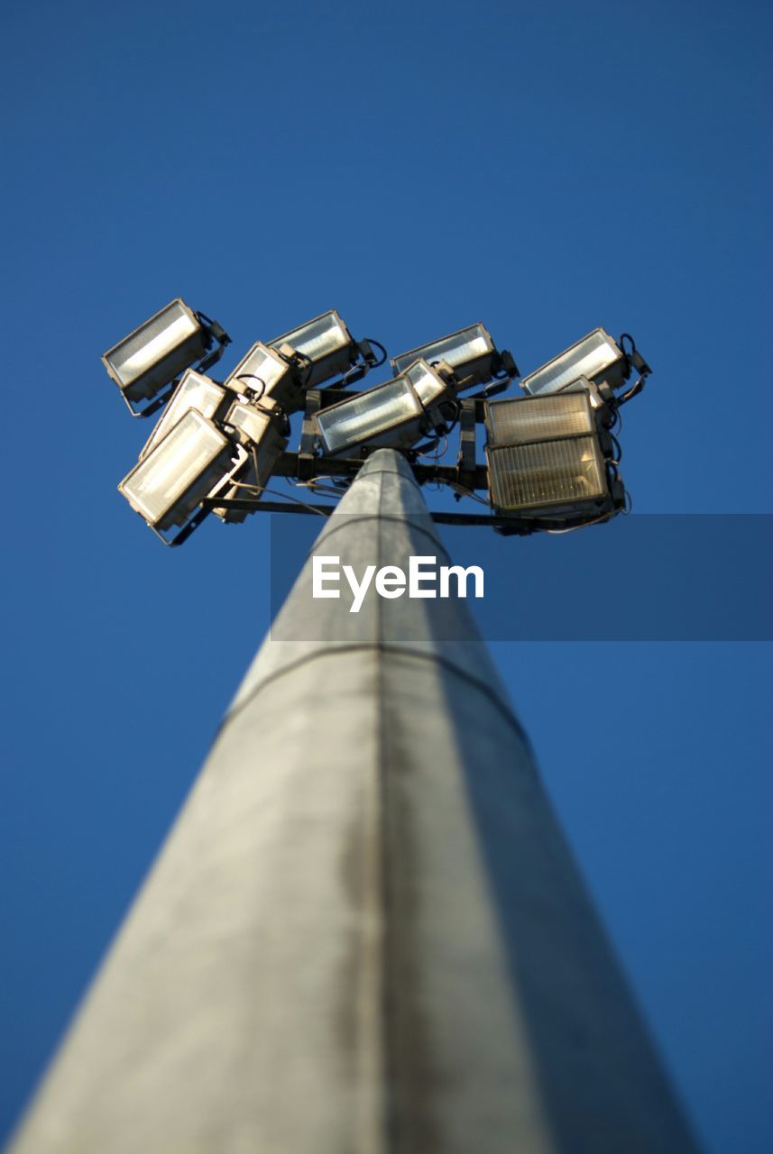 Low angle view of floodlight against clear blue sky