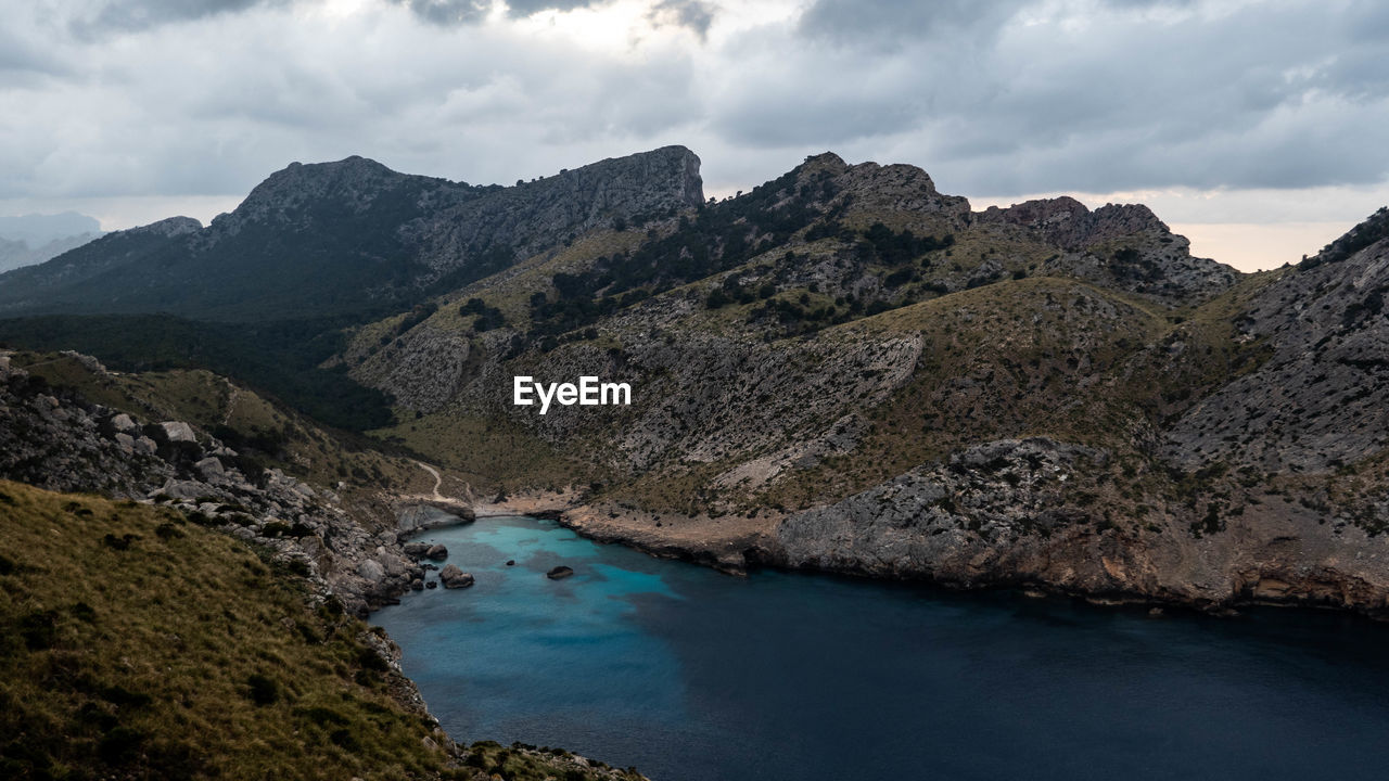 Scenic view of lake and mountains against sky