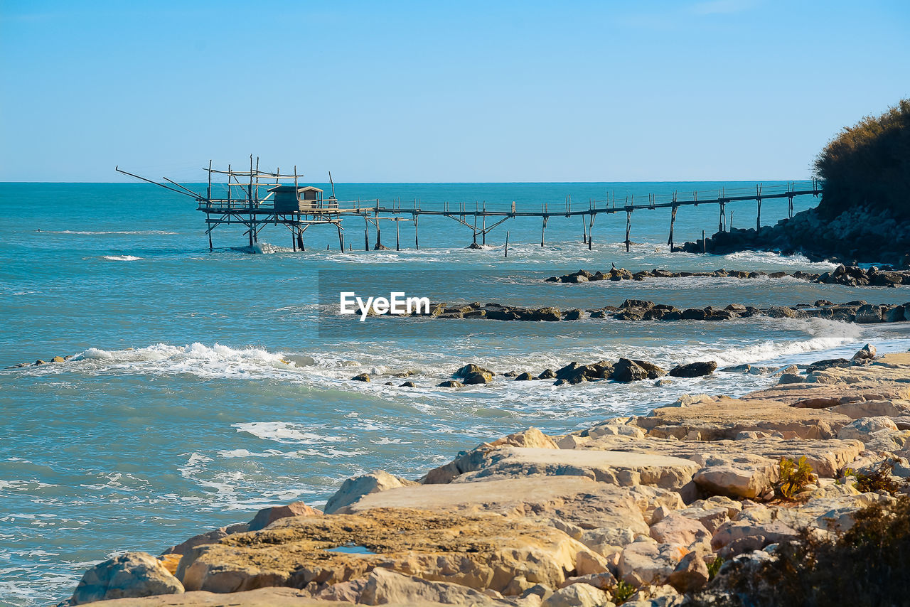 Scenic view of sea against clear blue sky