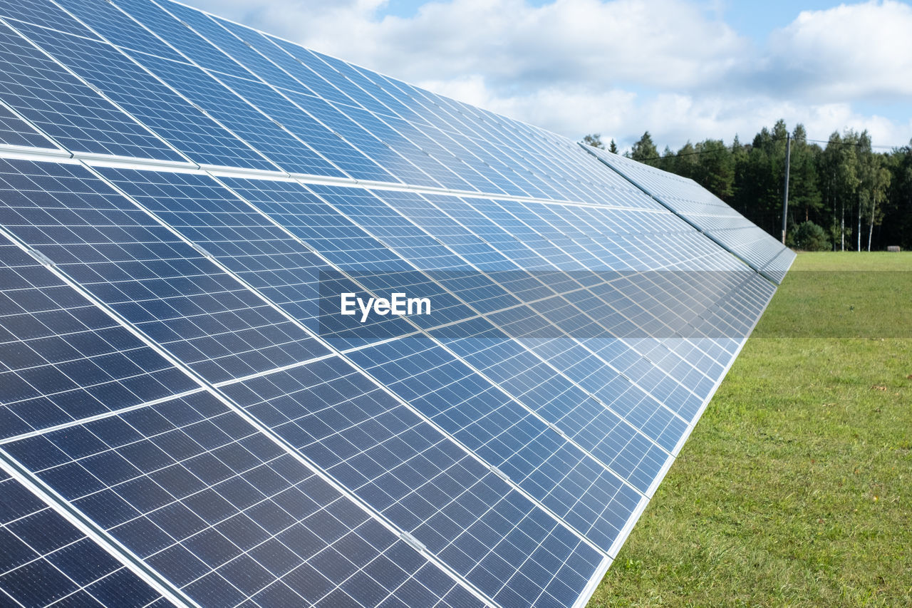 Solar panels on a green grass field