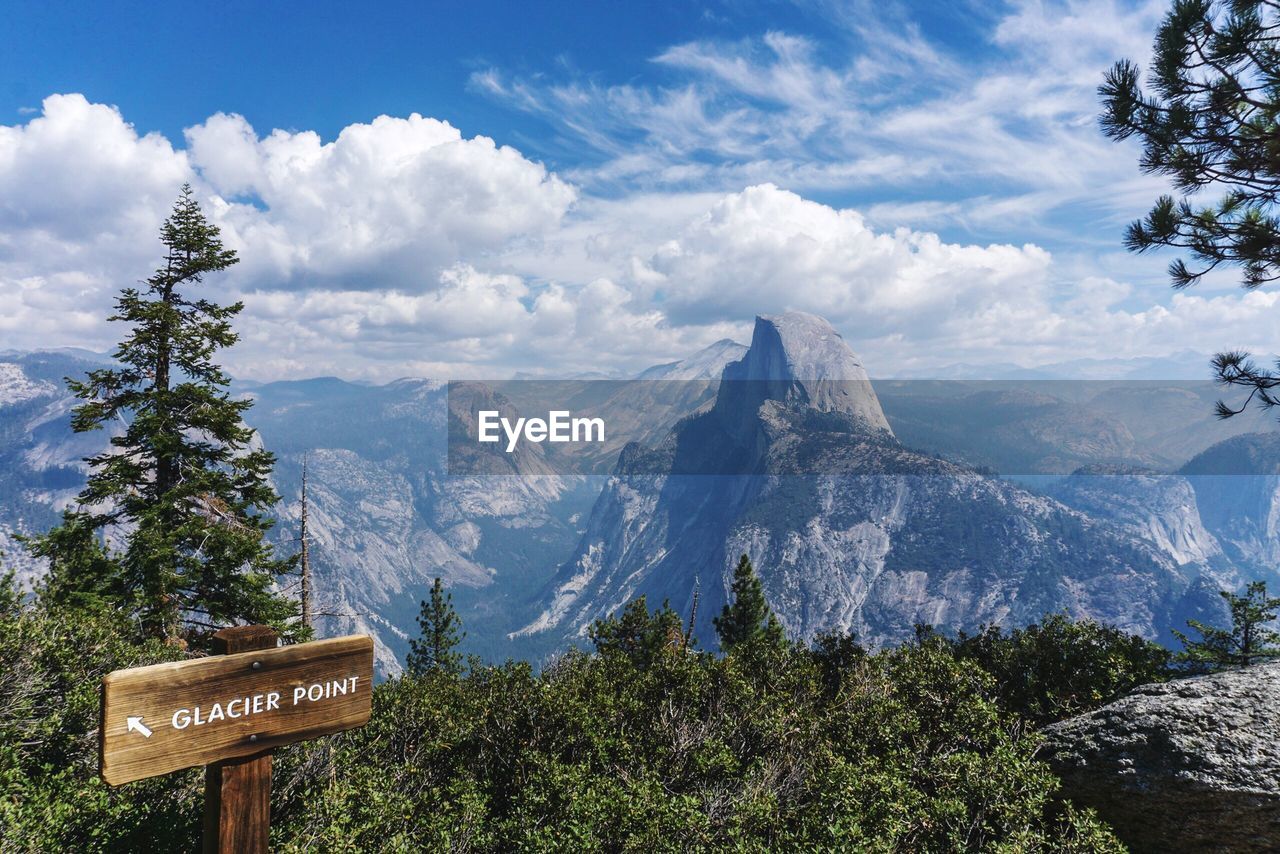 INFORMATION SIGN ON MOUNTAIN AGAINST SKY