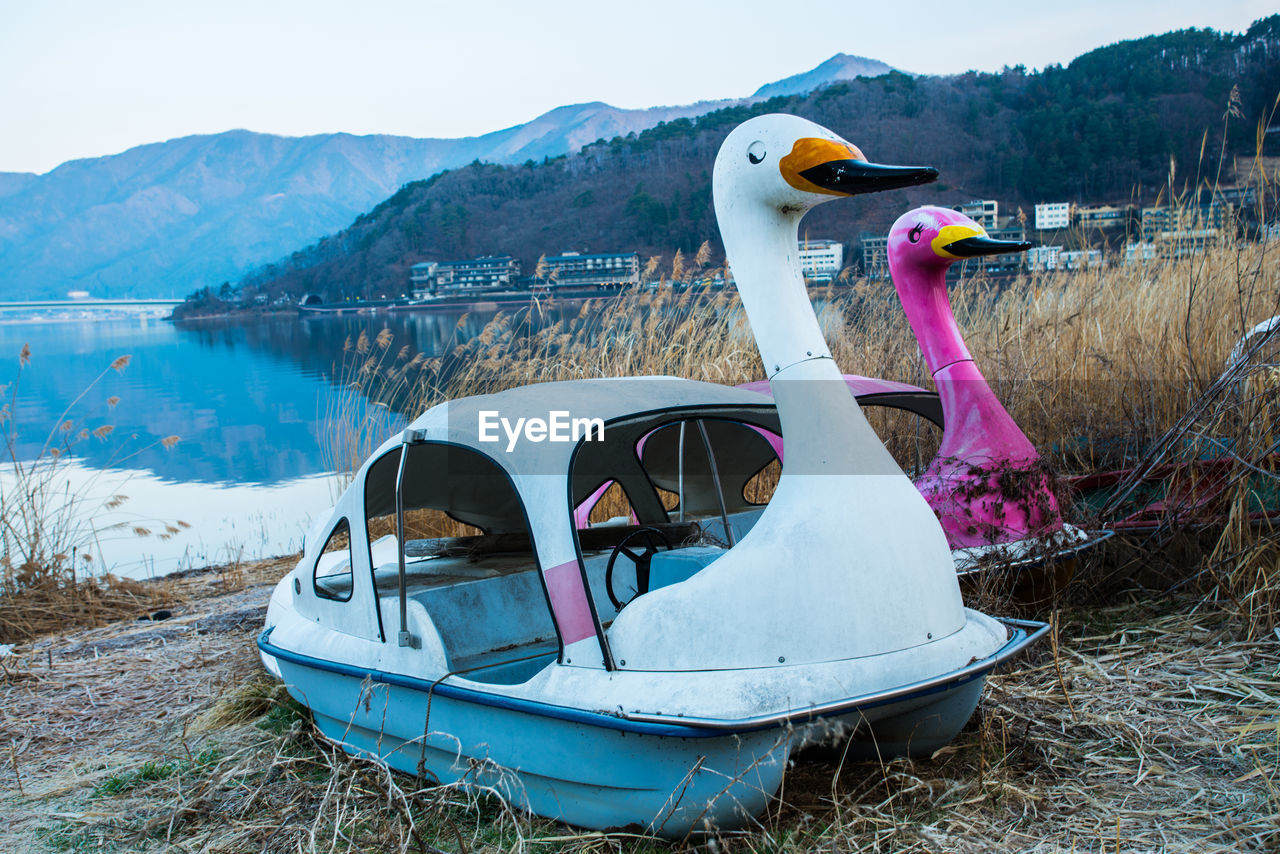 Abandoned pedal boats at lakeshore