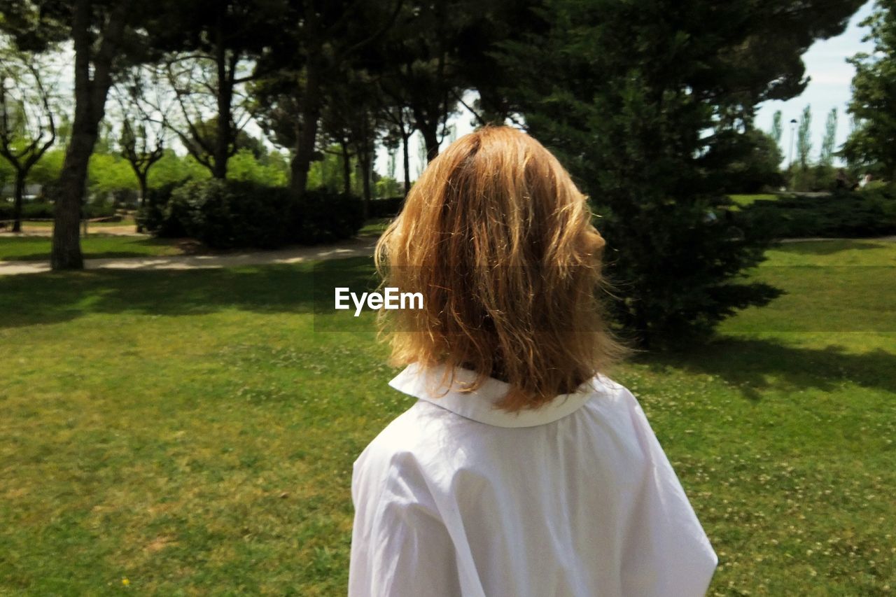 Rear view girl standing in garden