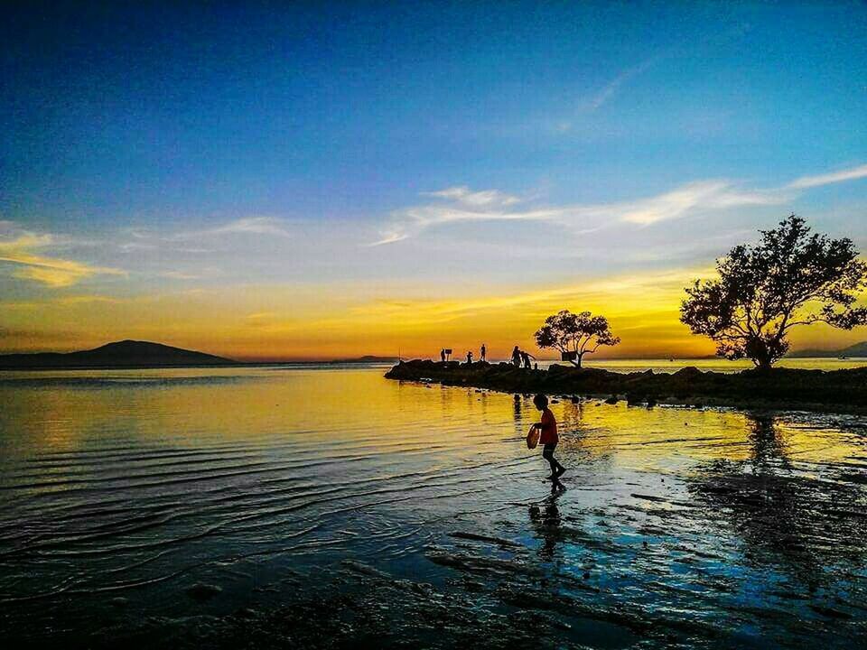 SCENIC VIEW OF SUNSET OVER SEA