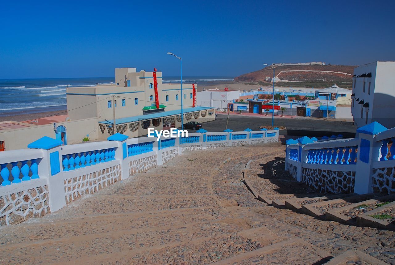 Scenic view of beach against clear blue sky