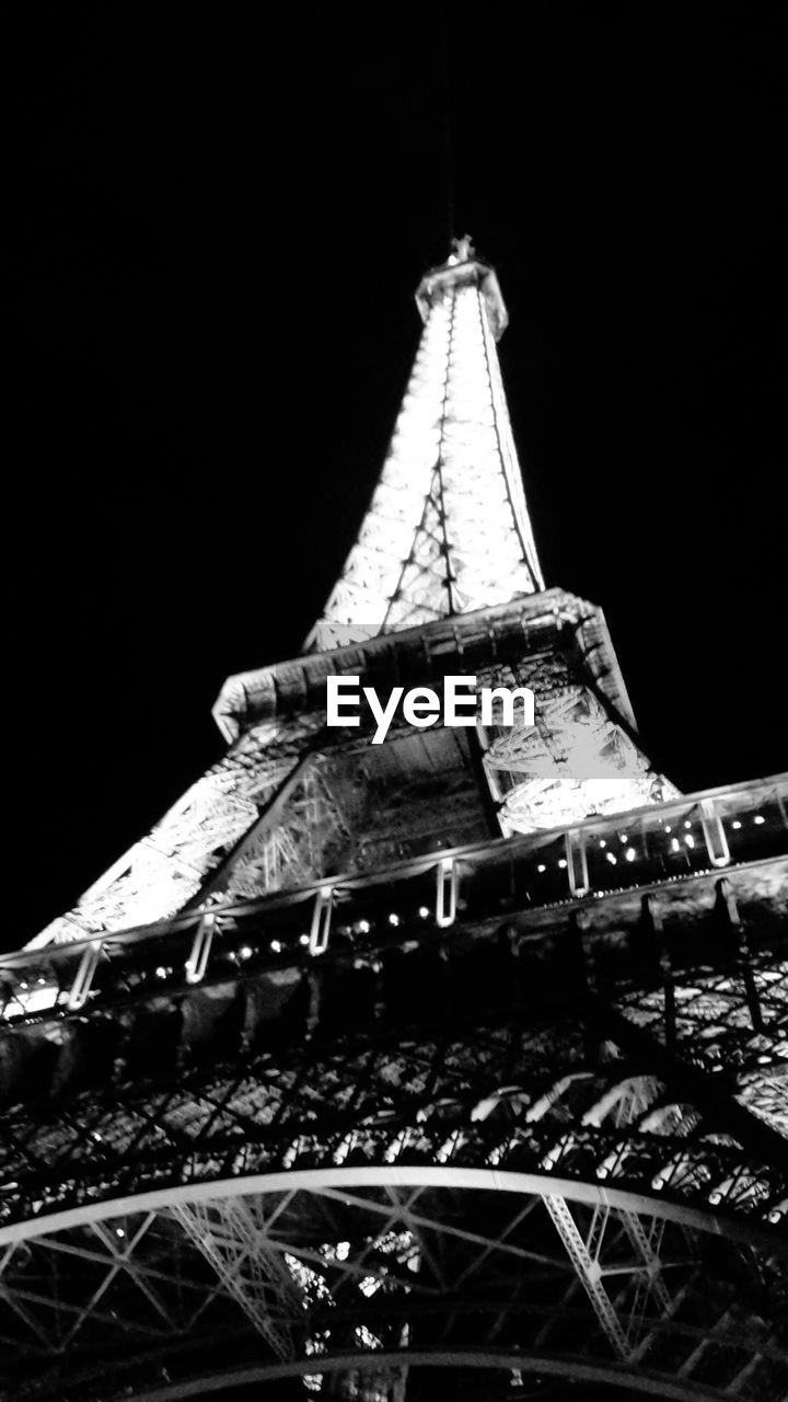 LOW ANGLE VIEW OF EIFFEL TOWER AT NIGHT