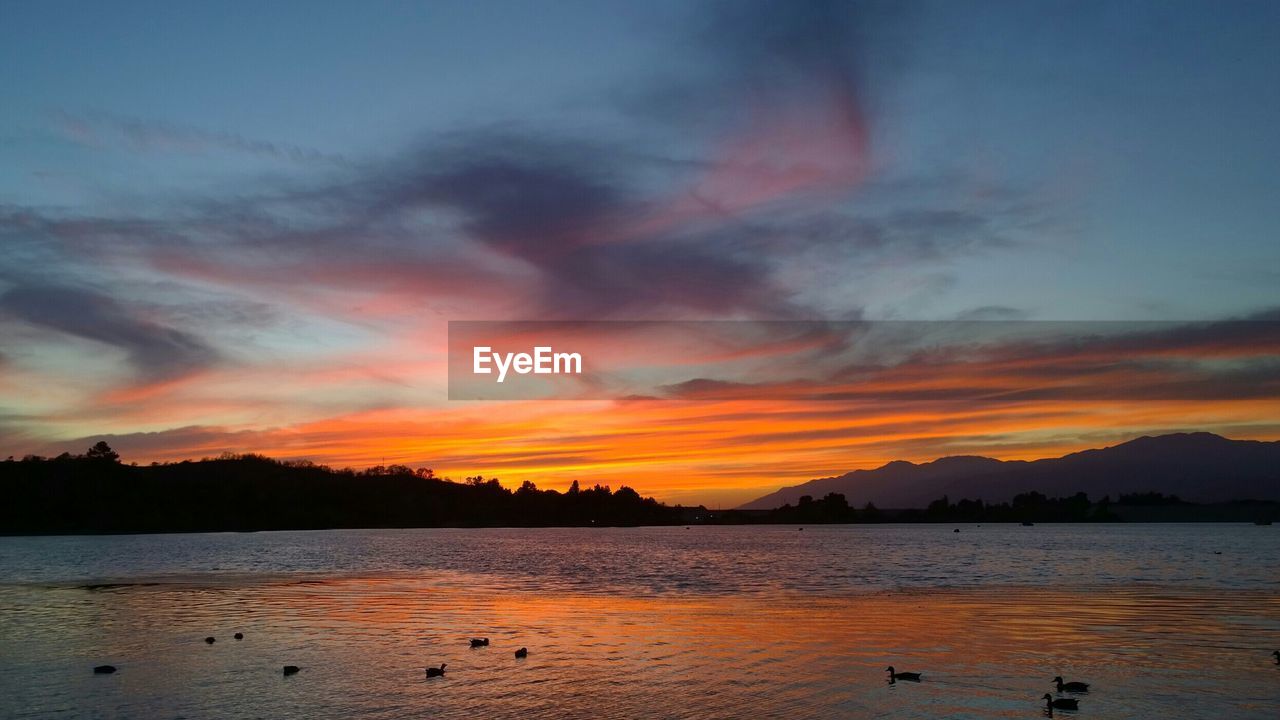 SCENIC VIEW OF SUNSET OVER SEA