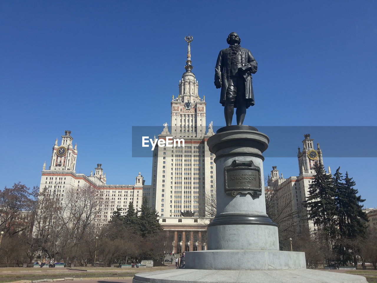 LOW ANGLE VIEW OF BUILDINGS AGAINST CLEAR BLUE SKY