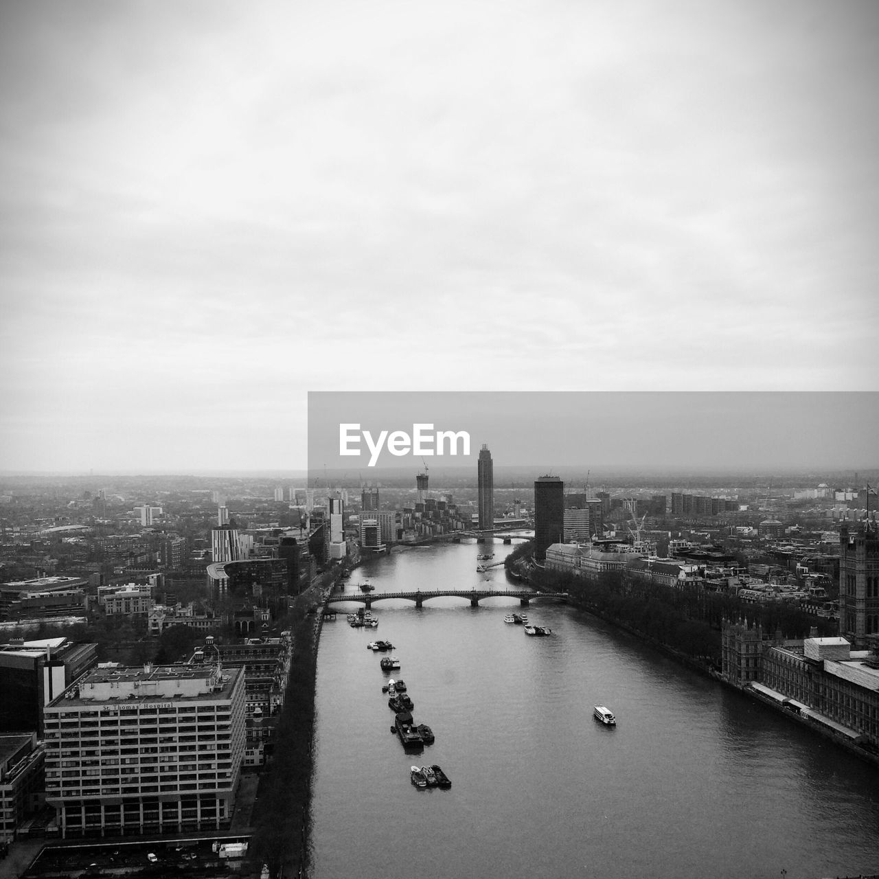 Aerial view of city against cloudy sky