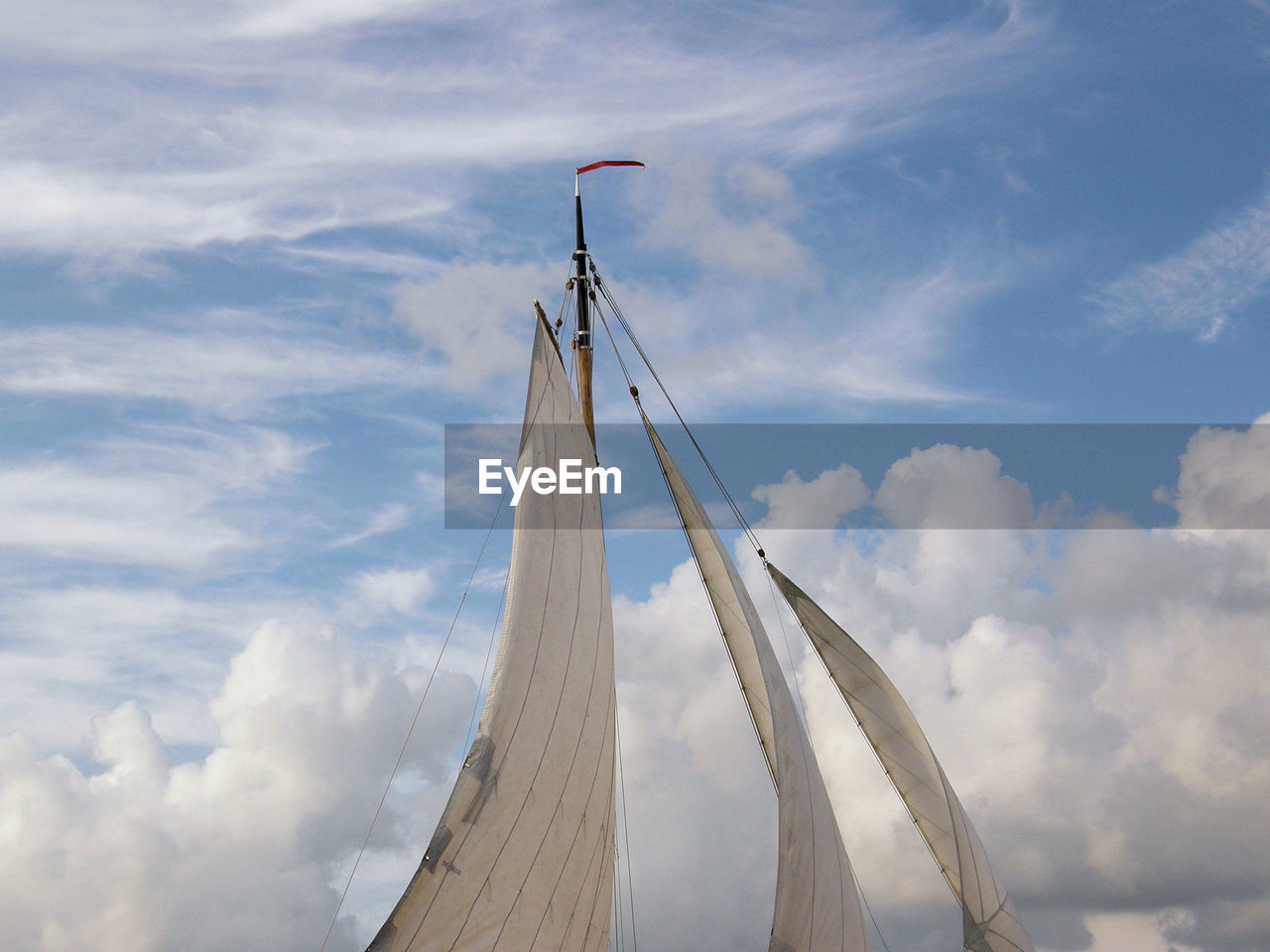 Low angle view of sailing ship against sky