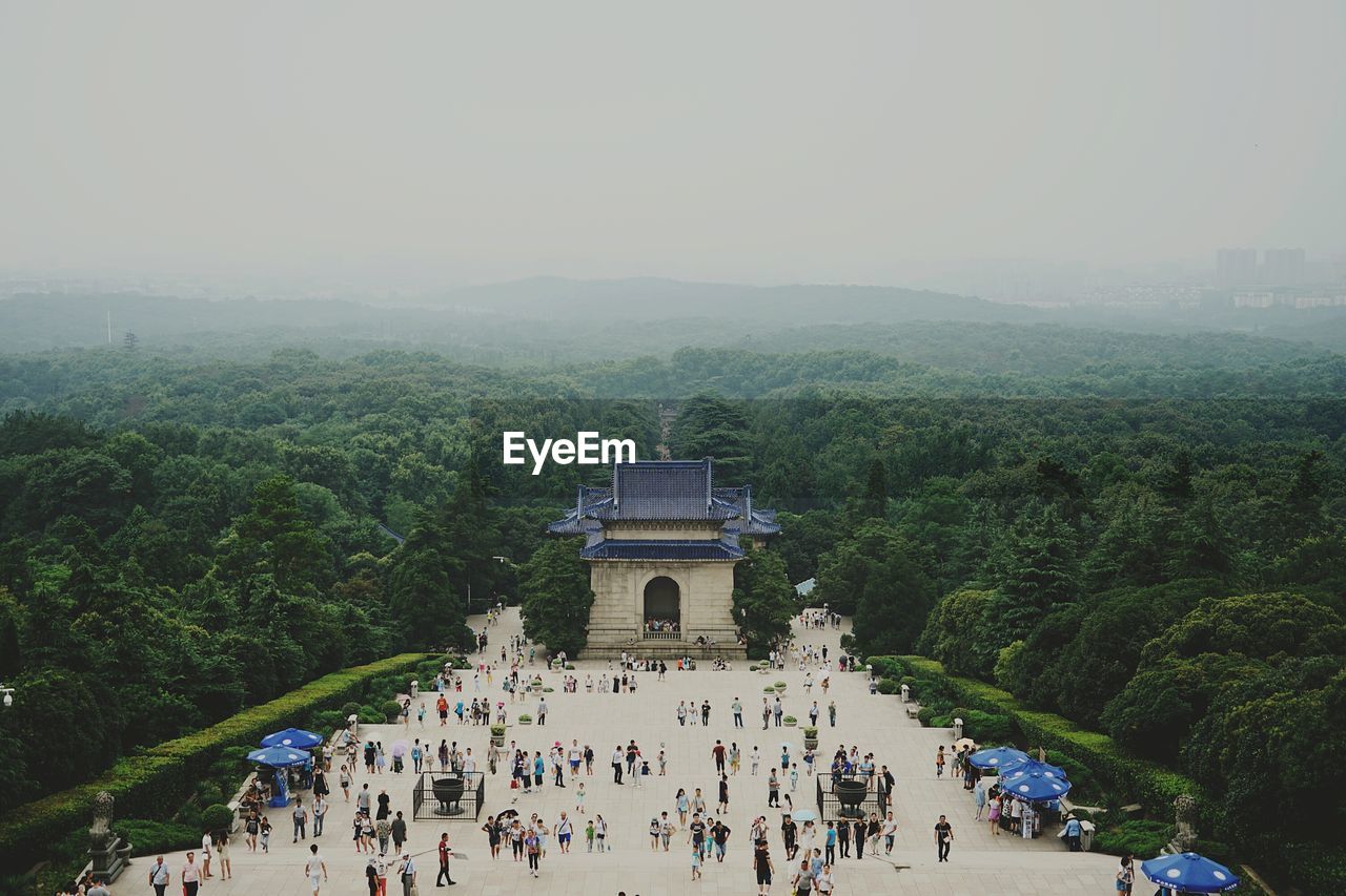 High angle view of crowd visiting sun yat-sen mausoleum surrounded by trees against sky