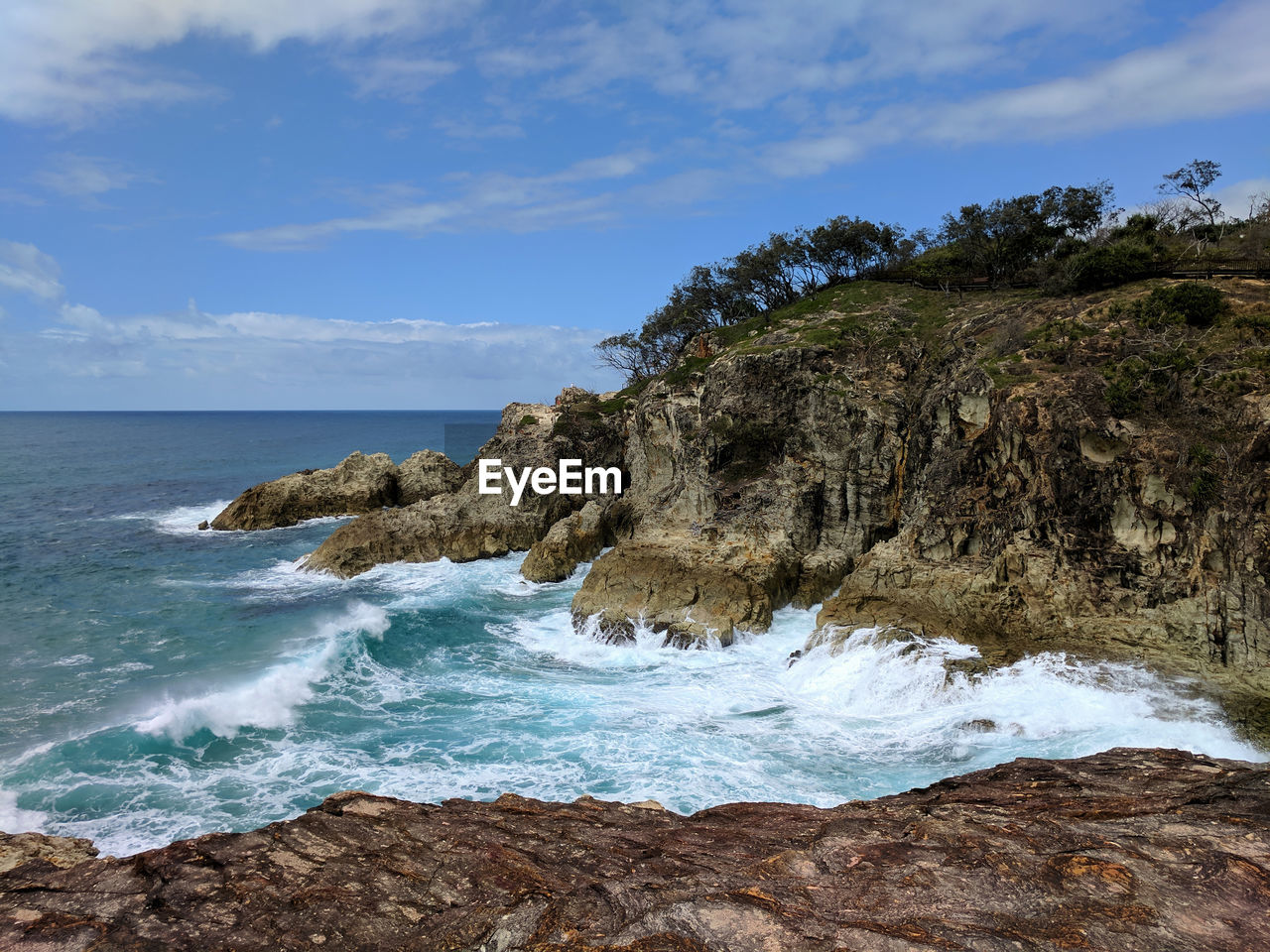 Scenic view of sea and rocks against sky