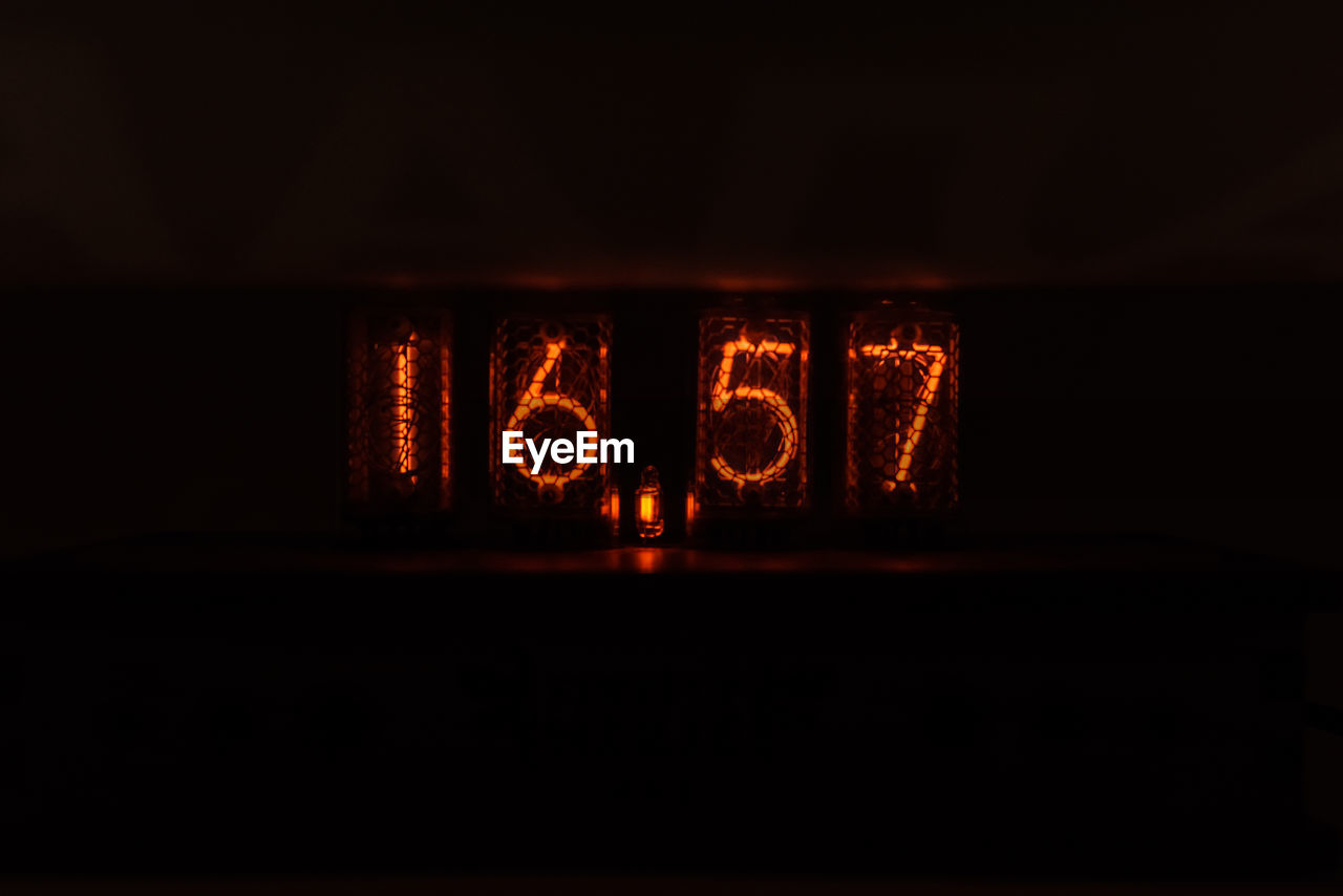 Close-up of illuminated numbers in darkroom