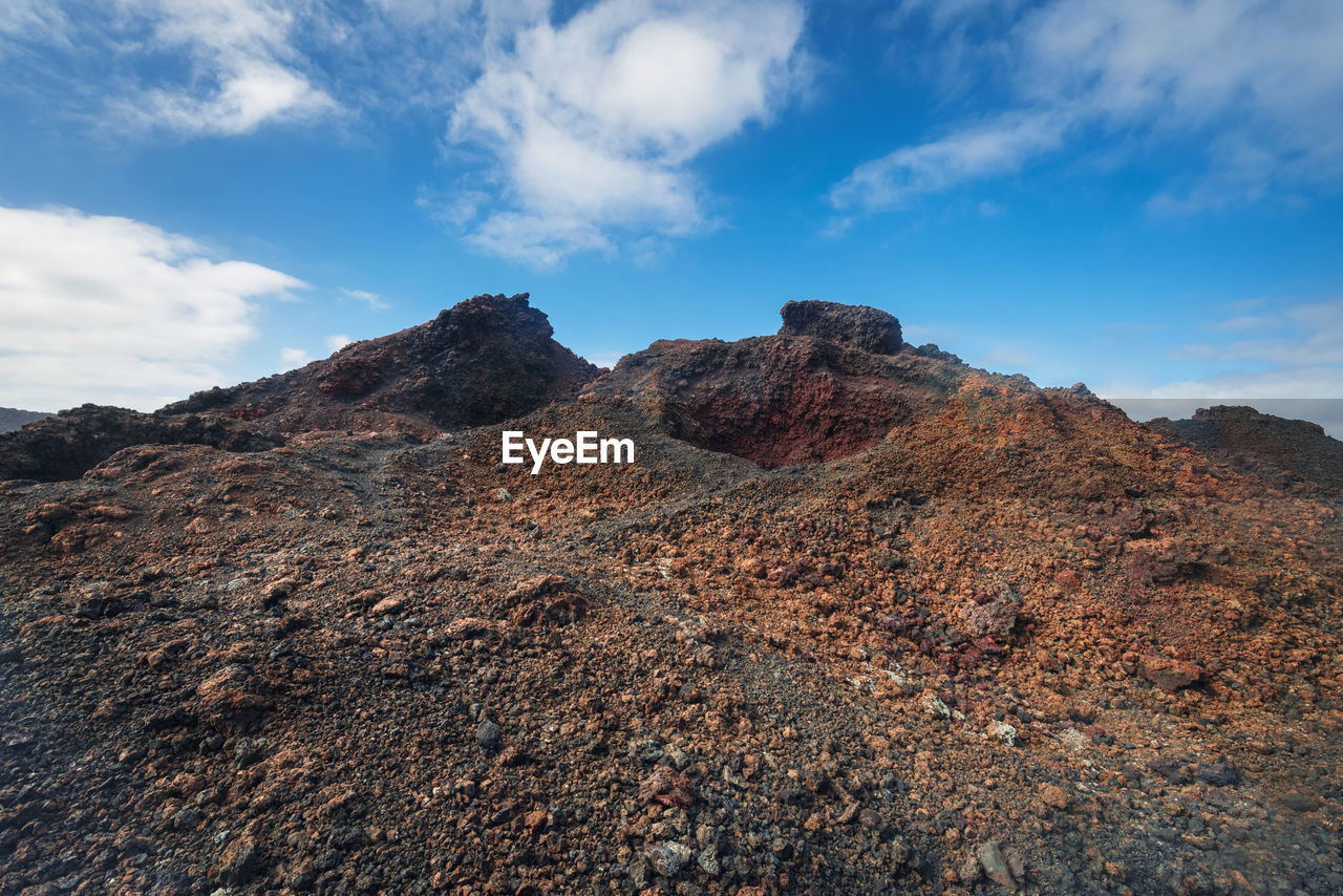 Low angle view of rock formations against sky