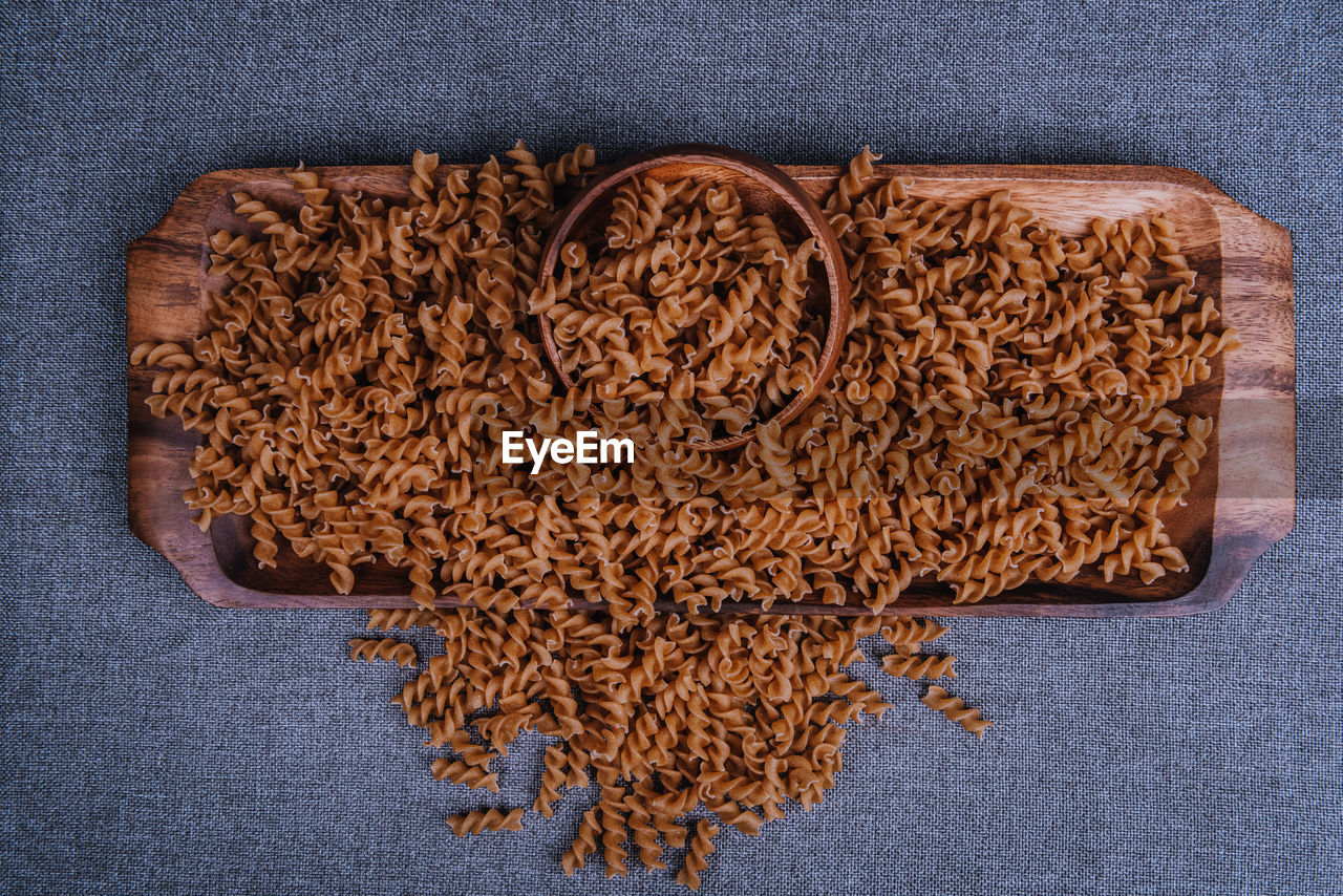 HIGH ANGLE VIEW OF BREAD ON TABLE AGAINST WALL