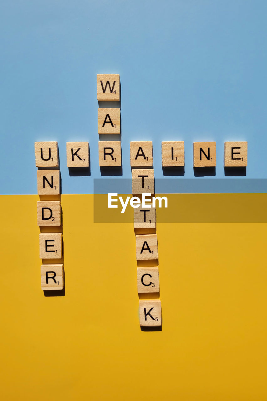 A lot of yellow stickers with words on blue background. concept of  support. stop war in ukraine