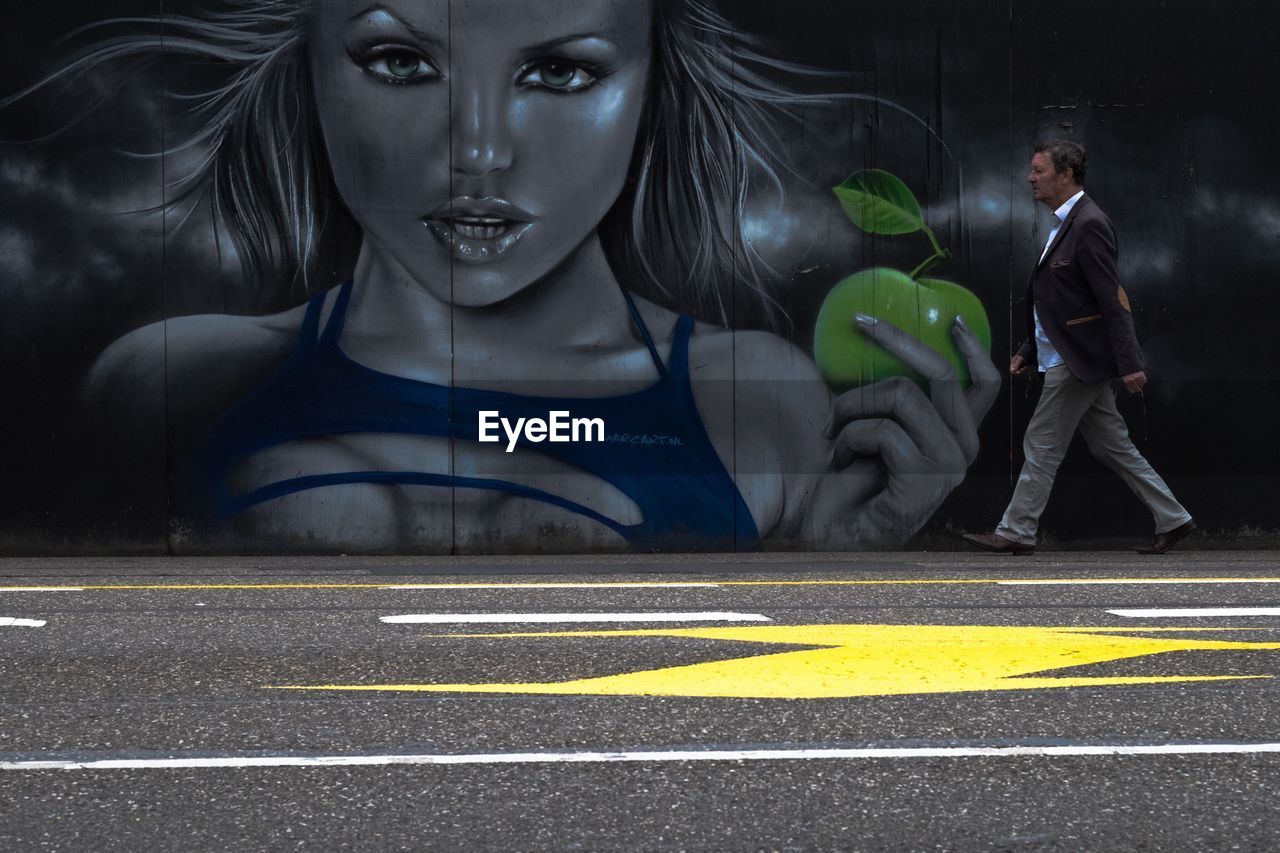 YOUNG WOMAN WITH ROAD IN BACKGROUND