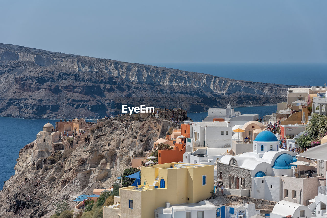 High angle view of buildings by sea against sky