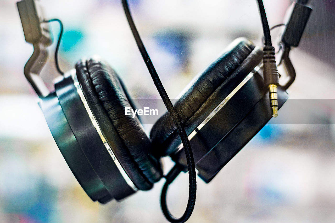 Close-up of headphones against glass window