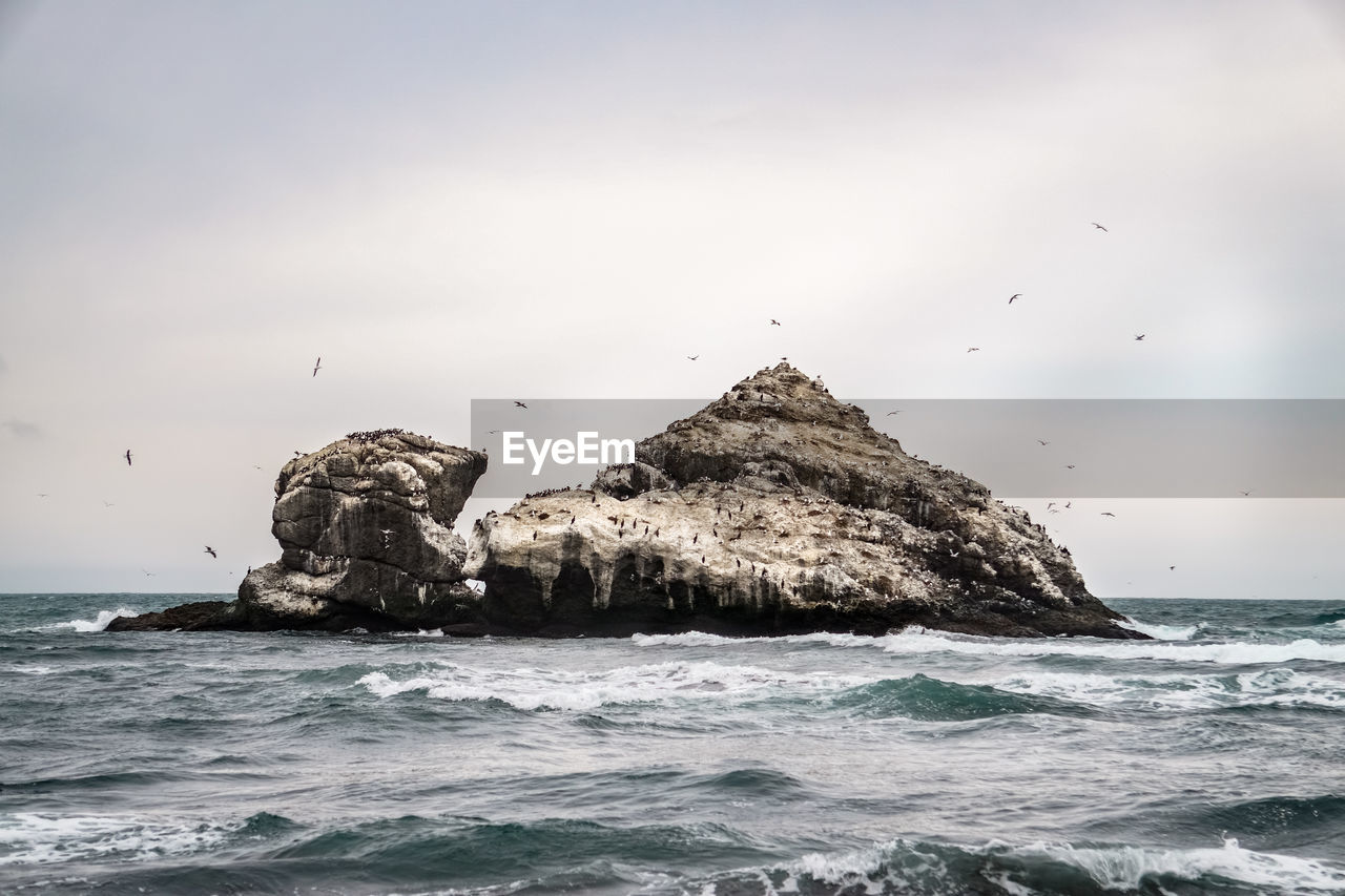 SCENIC VIEW OF SEA AGAINST ROCK FORMATION