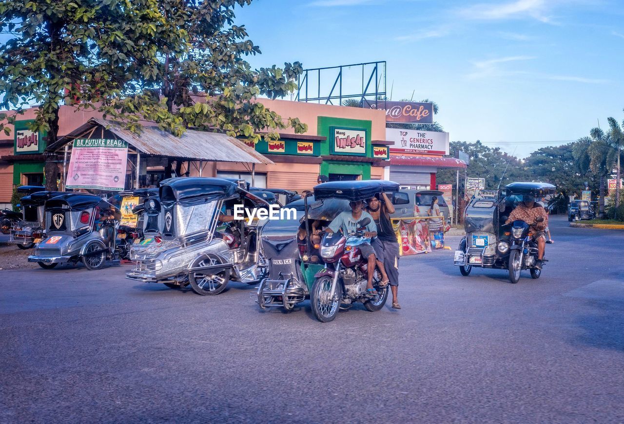 PEOPLE ON ROAD IN CITY