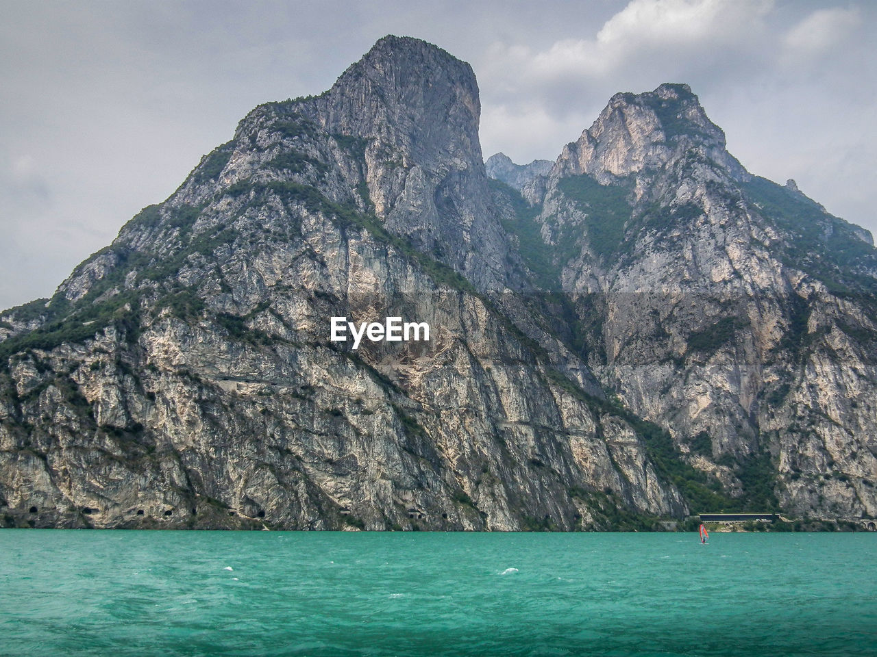 Scenic view of sea and mountains against sky