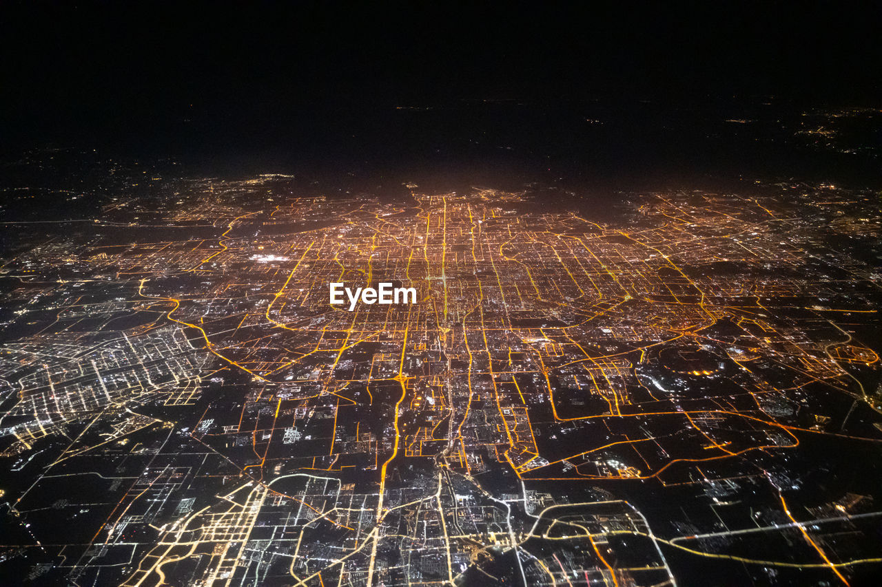 high angle view of illuminated buildings in city at night