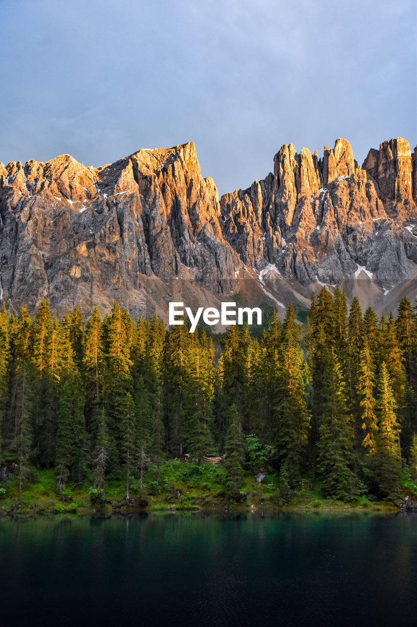 Scenic view of lake by mountains against sky