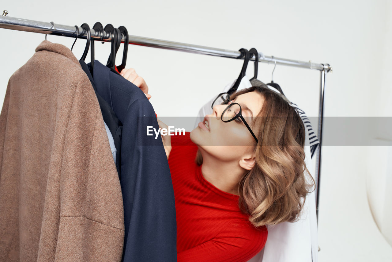 midsection of woman standing against window