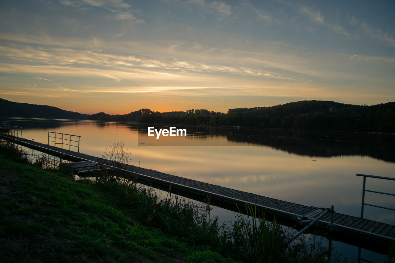 Scenic view of lake against sky during sunset