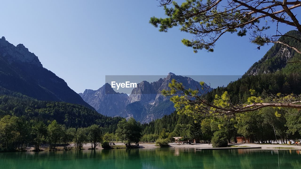 Scenic view of lake and mountains against clear sky