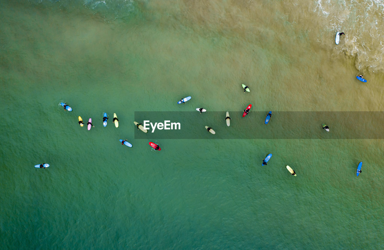 Aerial view of clean ocean waters with surfers