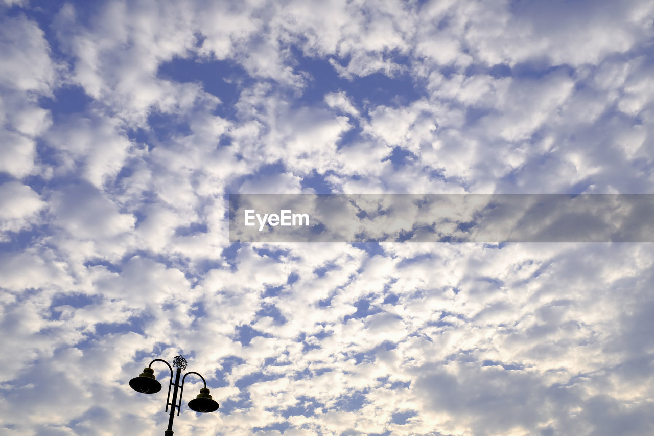 LOW ANGLE VIEW OF STREET LIGHT AGAINST SKY DURING SUNSET